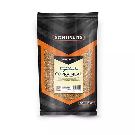 A 100g bag of Sonubaits Copra Meal ingredients, featuring a black and orange geometric design with a clear window showing the brown tan copra meal inside.